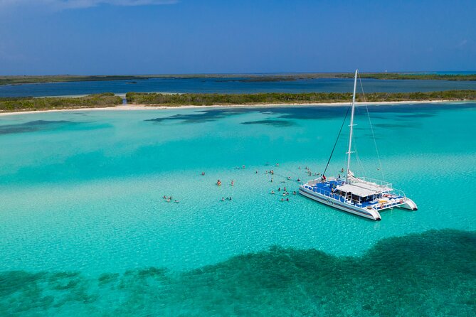 A catamaran anchored over the white sand of El Cielo, Cozumel